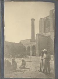 Men praying in front of the Madrasa-i Ulugh Beg in Samarkand