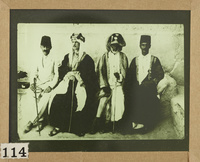 A Western agent in local costume with two Turkish officers and and old Arab man