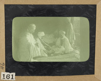 Five Arab men sit cross-legged on a carpet